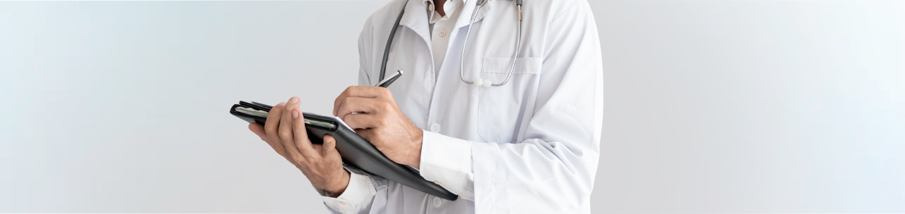 um médico vestindo jaleco branco e estetoscópio, escrevendo notas em uma prancheta ou pasta preta com uma caneta. O fundo é neutro e claro.